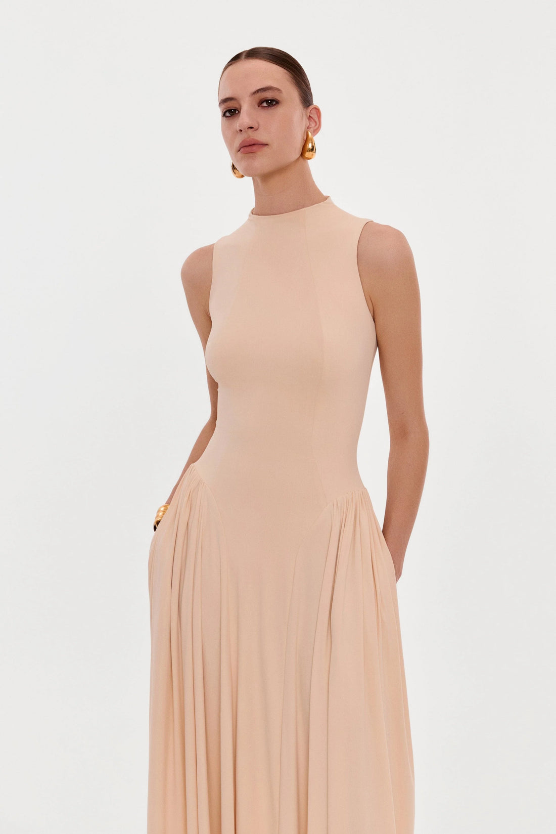Sleeveless high-neck maxi dress with a pleated skirt